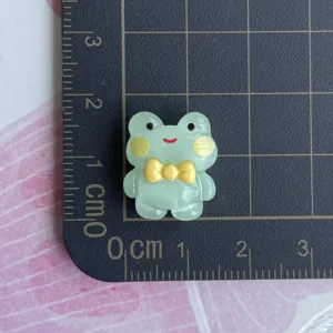 Mini resin frog charm detail shot, cute animal DIY accessory for phone case and crafts.