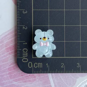 Mini translucent light blue resin bear charm with pink bow for phone case decor items.