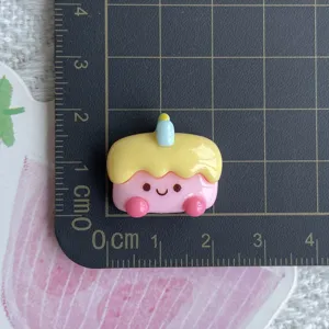 Cute resin cake charm with candle and smile face, perfect for DIY phone case and hair clip accessories.
