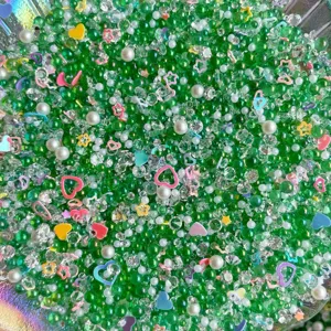 Mixed DIY green resin bubble beads crystal rhinestones pearls and colorful heart sequins for crafts.