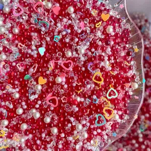 Mixed DIY red bubble beads rhinestones pearls and colorful heart sequins for slime craft.