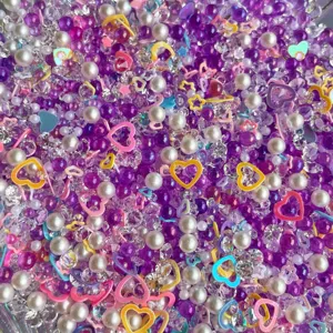 Mixed DIY bubble beads, fake pearls and colorful resin heart sequins for craft and slime decor.