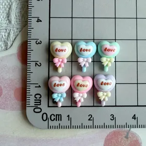 Resin heart lollipop bow cabochons detail view for nail art and DIY jewelry making accessories.