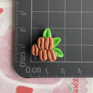 Détail de breloque feuille verte de noix de simulation en résine, parfait pour étui de téléphone DIY.