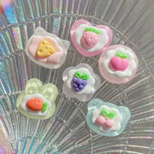 Close-up of glossy transparent fruit resin cabochons, perfect for DIY phone case and keychain crafts.