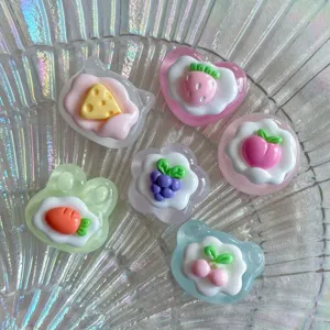 Glossy transparent resin fruit and cake cabochons detail, perfect for DIY phone case crafts.