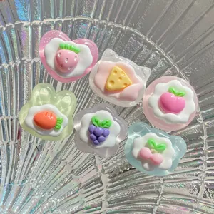 Resin DIY charms detailed shot featuring cute fruit and dessert shapes like strawberry and grape.