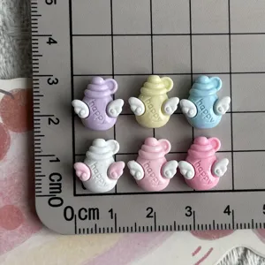 Mini resin angel bottle charms with wings, perfect for DIY nail art and jewelry making.
