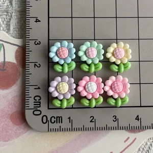 Cute mini resin flower charms for nail art and DIY jewelry making, colorful floral studs.