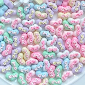 Colorful heart resin cabochons with LOVE text for nail art DIY jewelry making and crafts.