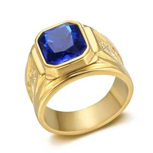 Close-up of a men's gold ring featuring a blue square gemstone and dragon engraving