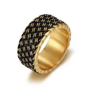Macro view of a vintage woven stainless steel ring with black and gold metallic texture