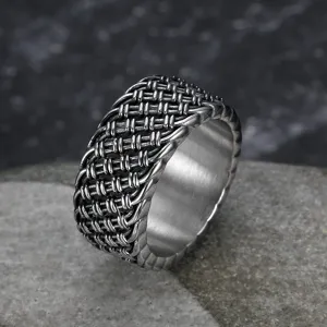 Macro detail of a vintage braided stainless steel ring for men with a distressed finish