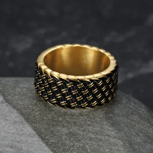 Detailed macro view of vintage woven stainless steel ring with gold and black punk texture