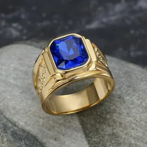 Close-up of golden titanium steel men's ring with blue gemstone and dragon engraving