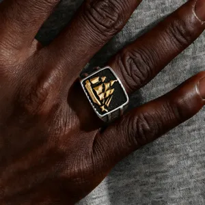 Vintage men's stainless steel ring featuring a golden sailing ship on black background.