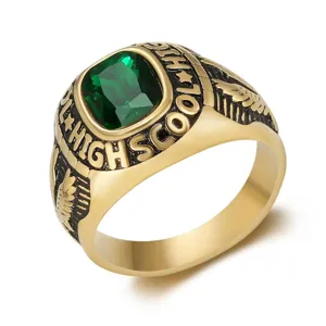 Detailed view of a vintage gold-plated eagle ring with an emerald-cut green stone