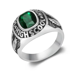 Close-up of vintage stainless steel signet ring with green gemstone and carved details