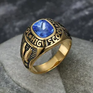 Close-up of vintage gold stainless steel eagle ring with blue gemstone and engraving detail