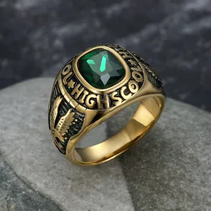 Detailed close-up of a vintage gold-tone eagle ring with a large green emerald-cut gemstone