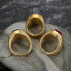 Detailed view of men's gold stainless steel rings with colorful zircon gemstones