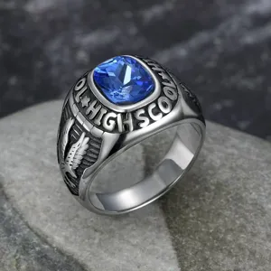 Close-up detail of vintage stainless steel ring with blue gemstone and eagle engraving