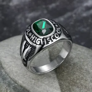 Macro view of retro stainless steel eagle ring with a green emerald-cut gemstone