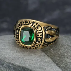 Close-up of vintage gold eagle ring with green gemstone and high school engraving