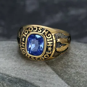 Macro view of vintage stainless steel class ring with blue gemstone and eagle detail