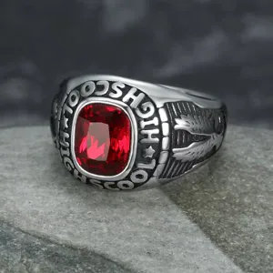 Close-up of retro punk stainless steel ring with red gemstone and eagle wing detail