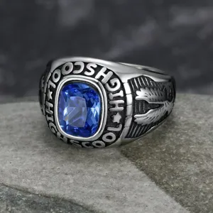 Macro detail of vintage stainless steel ring with blue gemstone and eagle carving