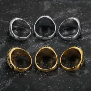 Rear view of gold and silver eagle engraved rings showing intricate punk textures