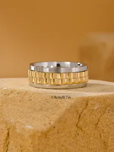 Detail macro view of a men's stainless steel spinner ring with watch band texture.