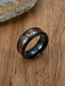Macro detail of men's stainless steel ring with wood inlay and deer silhouette