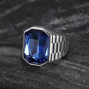 Macro shot of men's stainless steel ring with large blue square gemstone and textured band