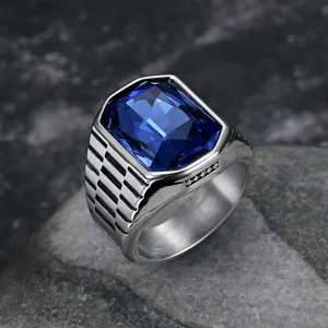 Macro view of hip-hop men's stainless steel ring with a large blue square gemstone detail.