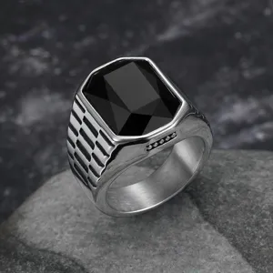 Close-up of a men's stainless steel hip-hop ring featuring a large black square gemstone