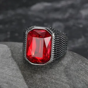 Detail view of vintage stainless steel ring featuring a large red emerald-cut zircon.