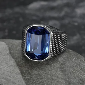 Detail view of vintage men's stainless steel ring with large blue rectangular faceted zircon