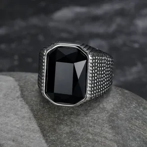 Macro view of men's vintage stainless steel ring with large black rectangular stone