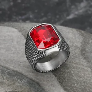Detailed view of a vintage stainless steel men's ring with a large red zircon gem.