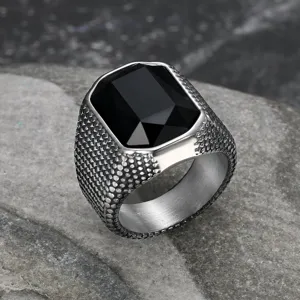 Close-up of men's retro stainless steel ring with faceted black gemstone