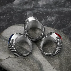 Detailed macro shot of vintage stainless steel rings featuring red and blue stones