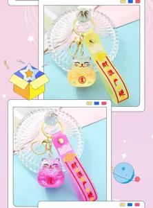 Close-up details of the cute quicksand lucky cat keychain, transparent acrylic charm and strap.