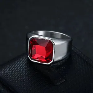 Detailed macro view of a vintage men's stainless steel ring with a square red crystal.