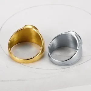 Detailed macro view of gold and silver finish stainless steel signet rings for men