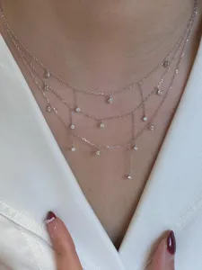 Close-up detail of multi-layer silver zircon tassel choker necklace sparkling nicely on neck.