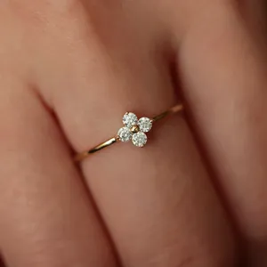 Delicate four-leaf clover diamond ring, elegant gold thin band for women daily wear.