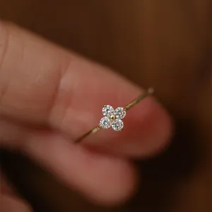Exquisite 925 silver four-leaf clover ring detail showing the delicate flower-shaped stone cluster.
