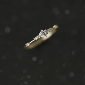 Primer plano detallado de un anillo fino de plata de ley con circonitas brillantes.